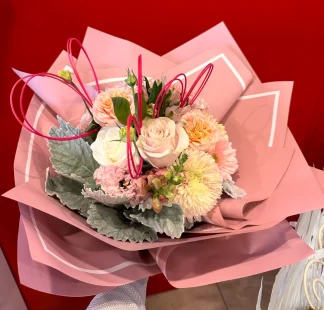 Pastel bouquet featuring roses, gerbera, dusty miller, crythansium, lisianthus, and whimsical blooms, exuding soft elegance and timeless beauty.